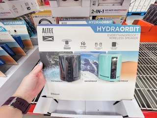 hand holding a 2-pack of altec lansing hydraorbit speakers