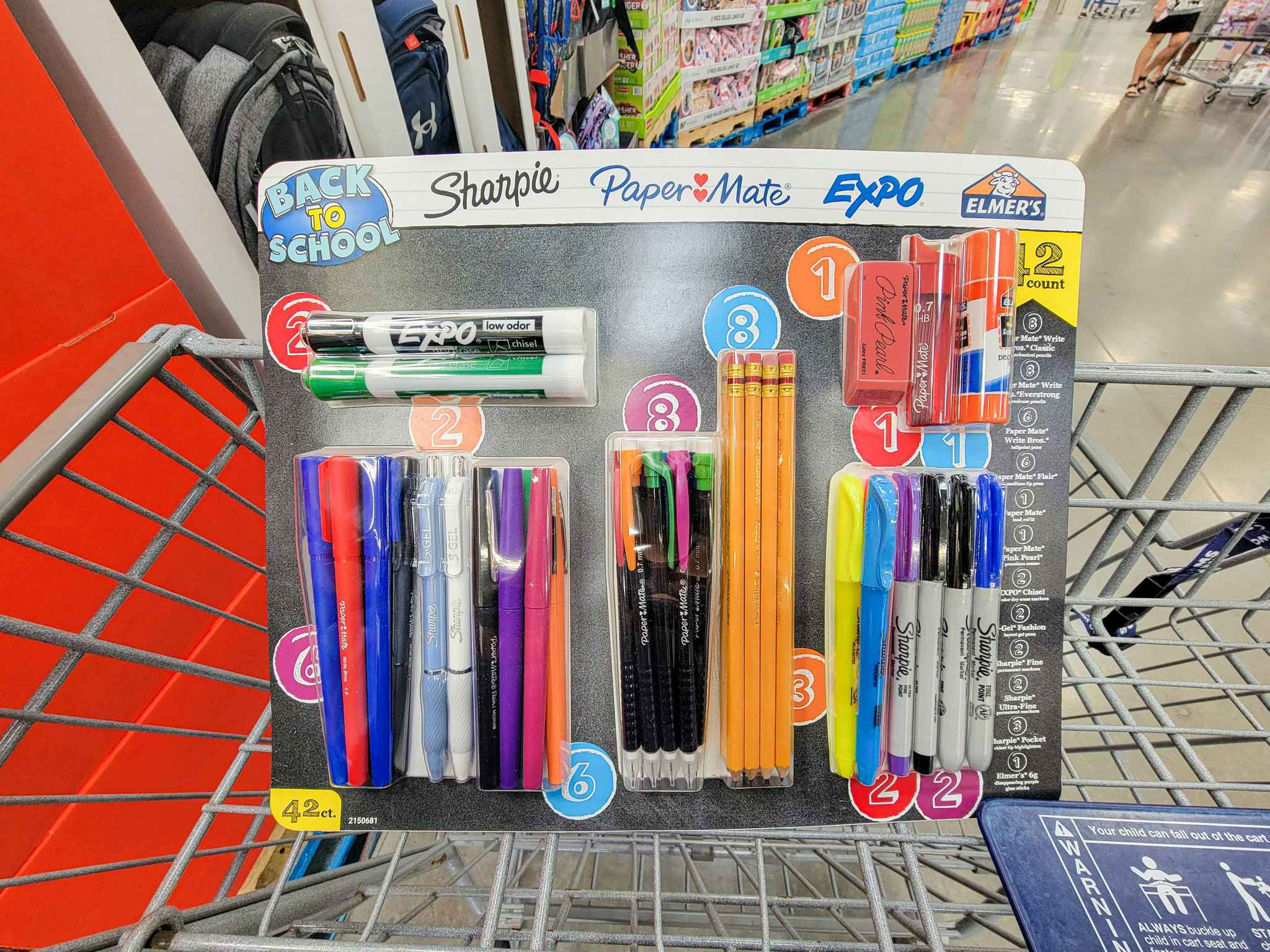 a back to school kit in a cart, containing pencils, pens, sharpies, dry erase markers, etc