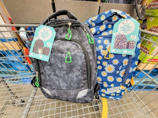 2 backpacks in a cart, that come with a matching lunch box