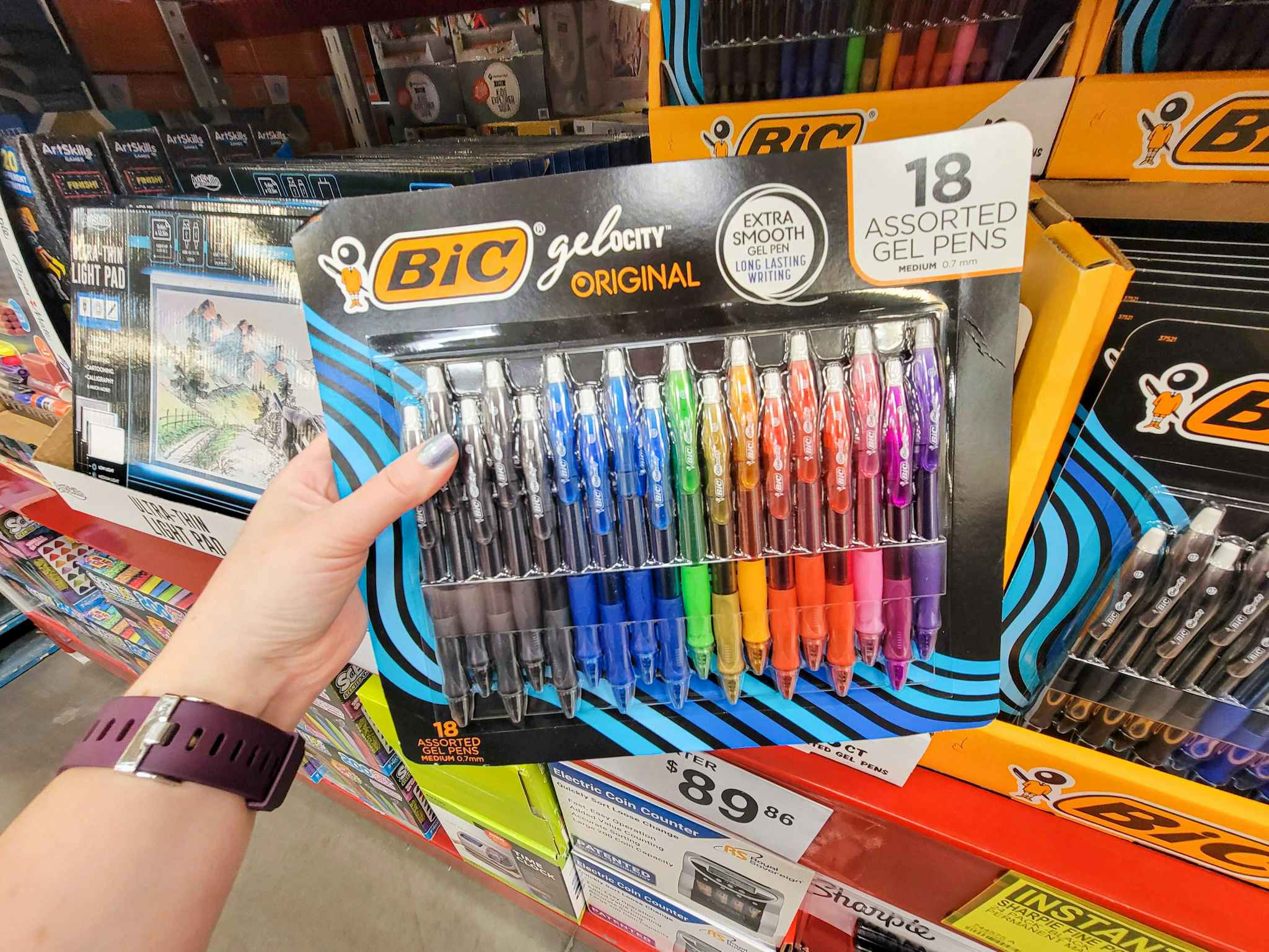 hand holding a pack of 18 bic gelocity multi colored pens