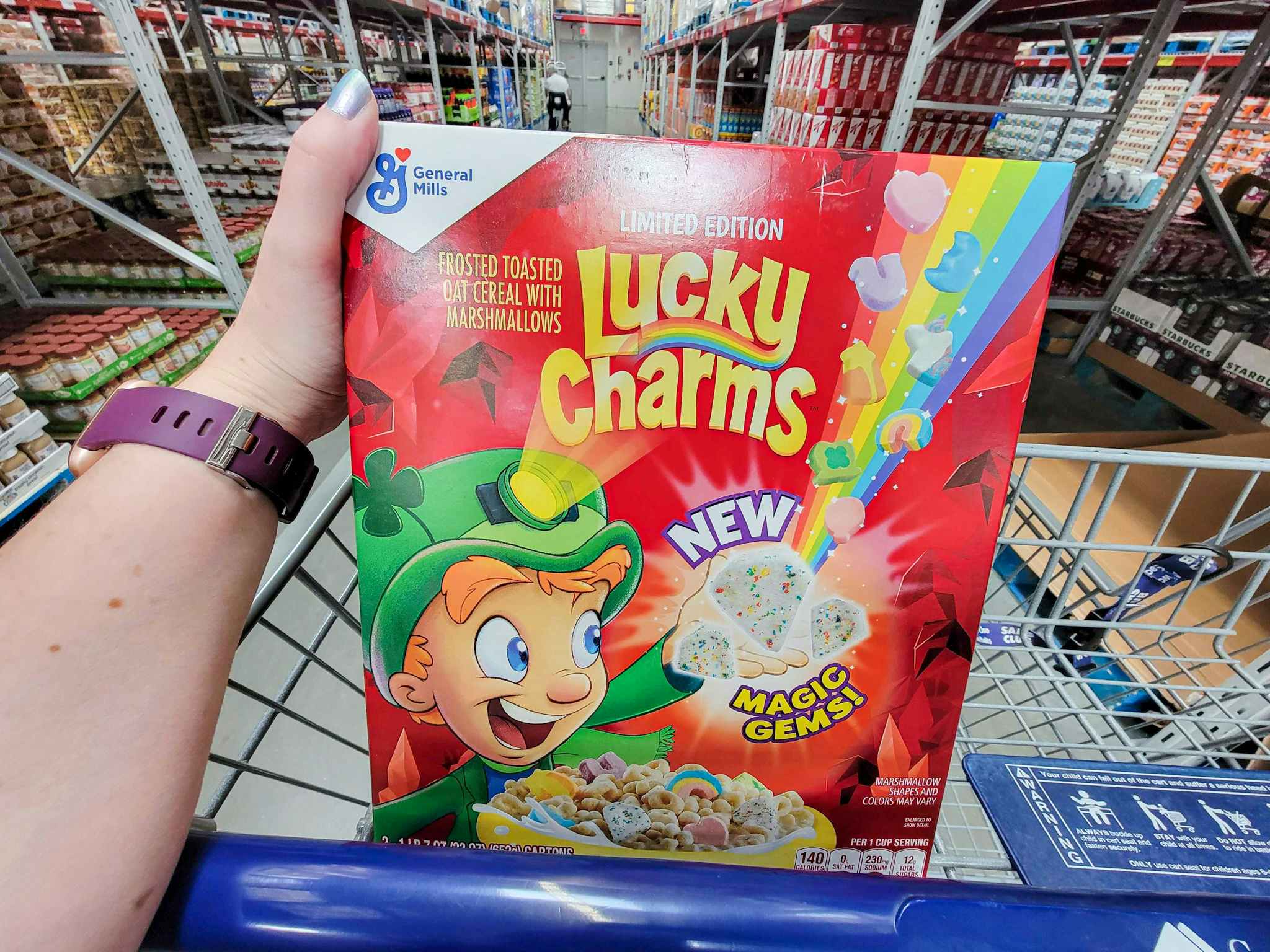 hand holding a 2-pack of lucky charms in a cart