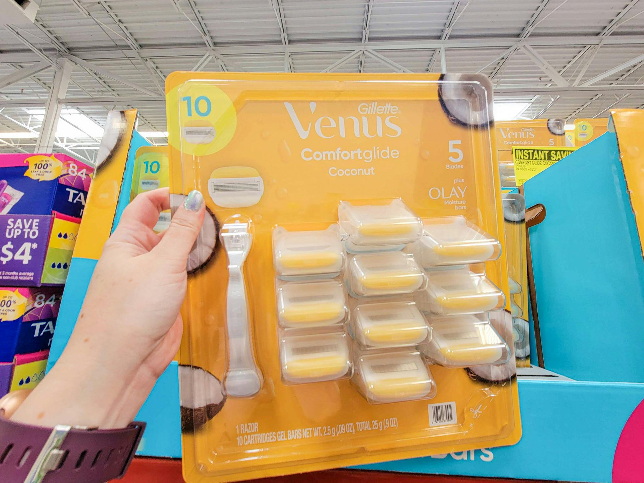 hand holding a gillette venus comfort glide coconut razors 10 pack plus handle