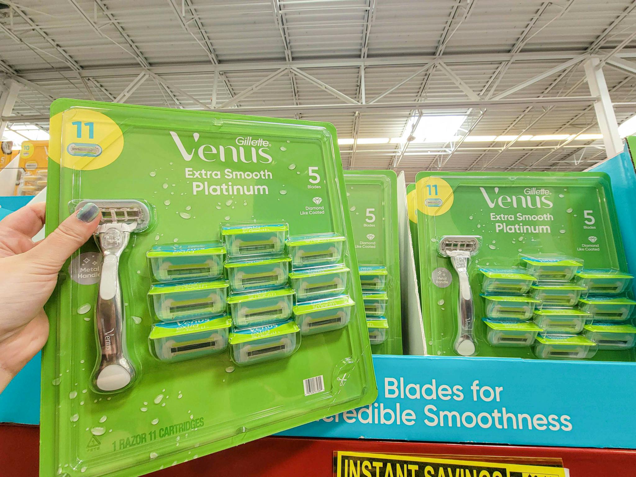 hand holding a pack of gillette venus extra smooth platinum razors 11 pack with handle