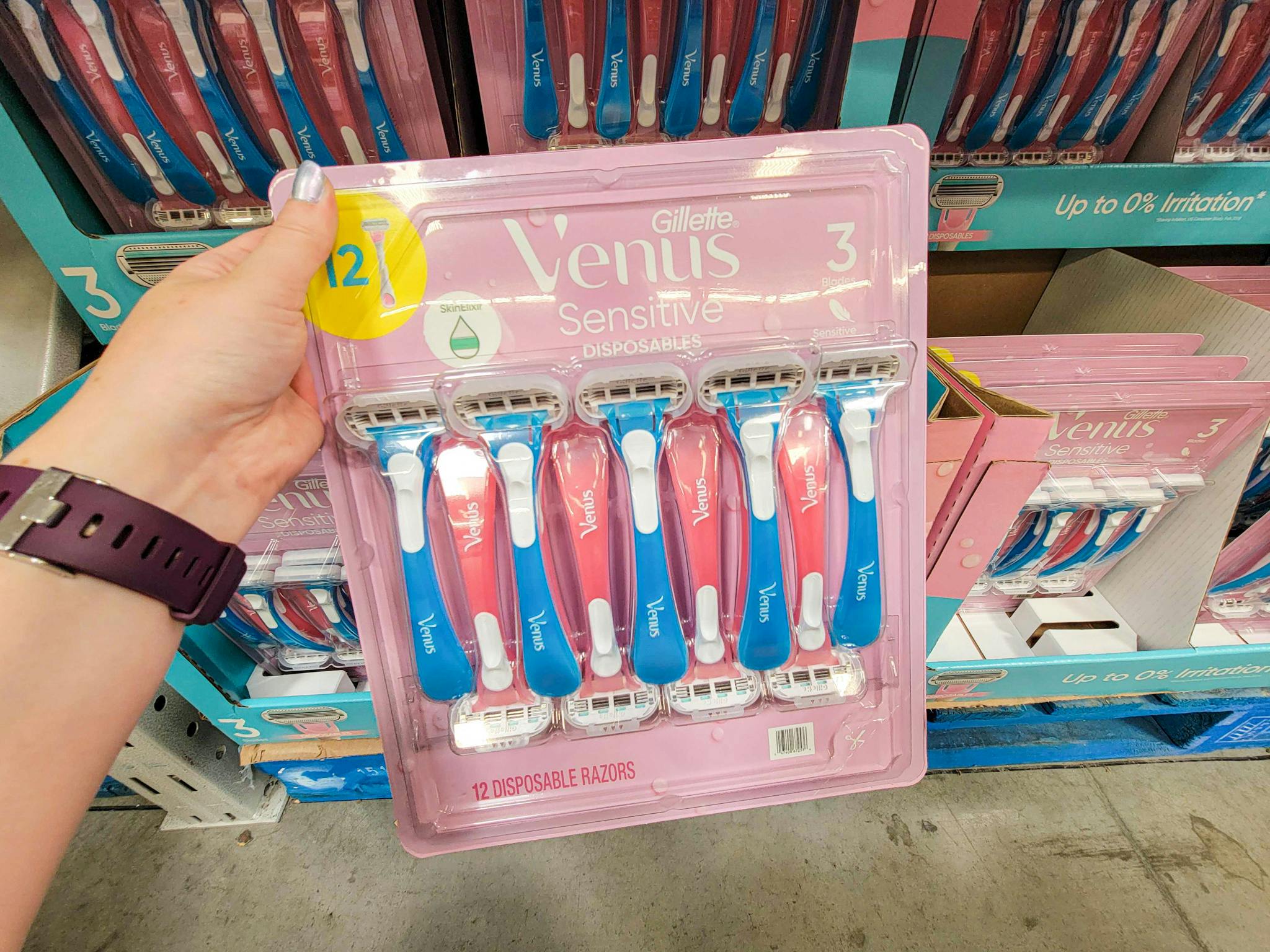 hand holding a pack of 12 gillette venus disposable razors