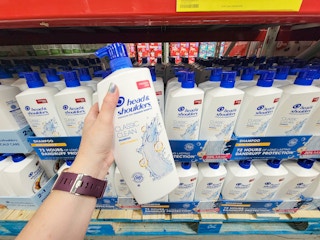 hand holding a large bottle of head and shoulders shampoo