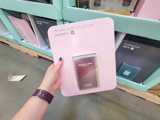 hand holding a michael kors perfume