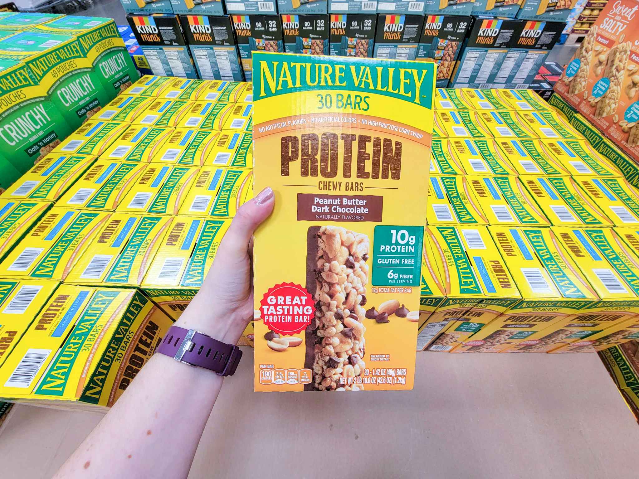 hand holding a box of nature valley protein bars