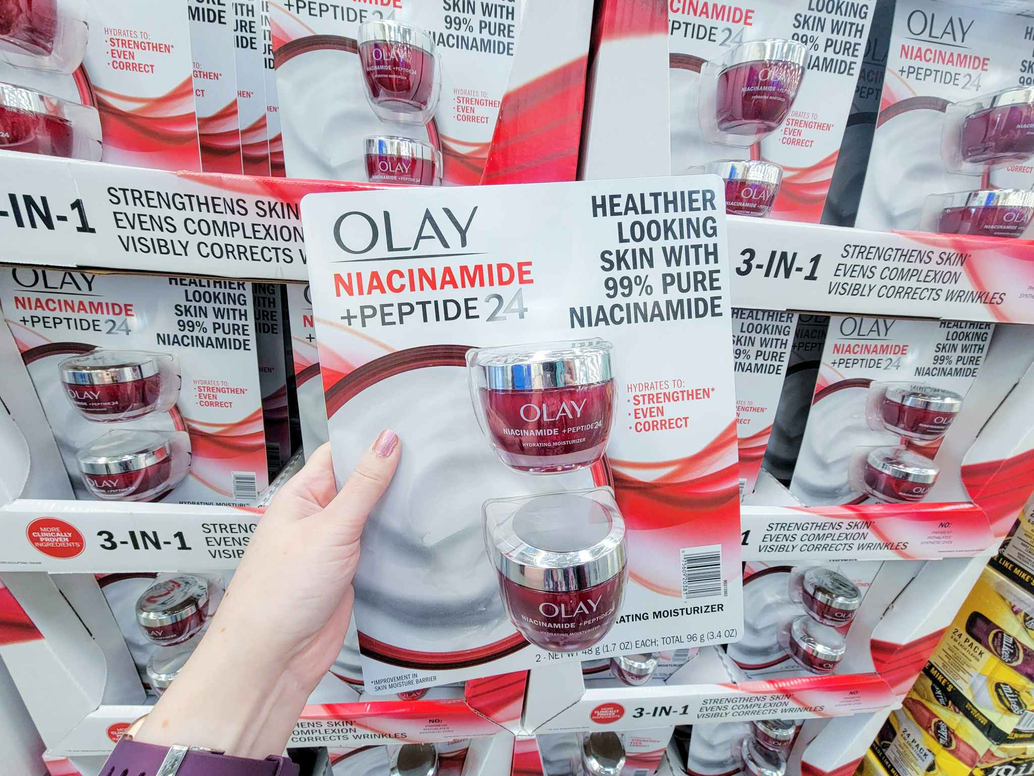 hand holding a 2-pack of olay moisturizer