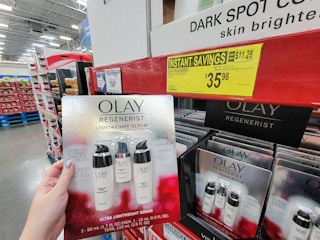 hand holding a 3 pack of olay lightweight regenerist serums