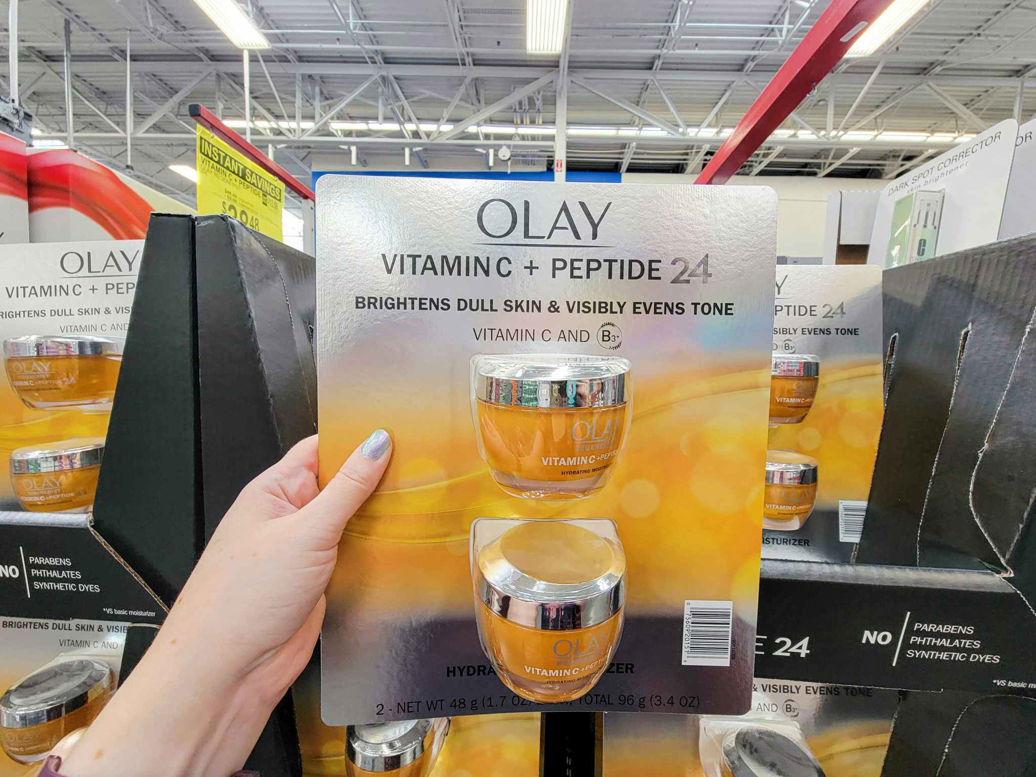 hand holding a 2 pack of olay vitamin c plus peptide moisturizer