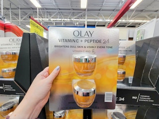 hand holding a 2 pack of olay vitamin c plus peptide moisturizer