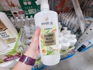 hand holding a large bottle of pantene coconut milk and avocado shampoo