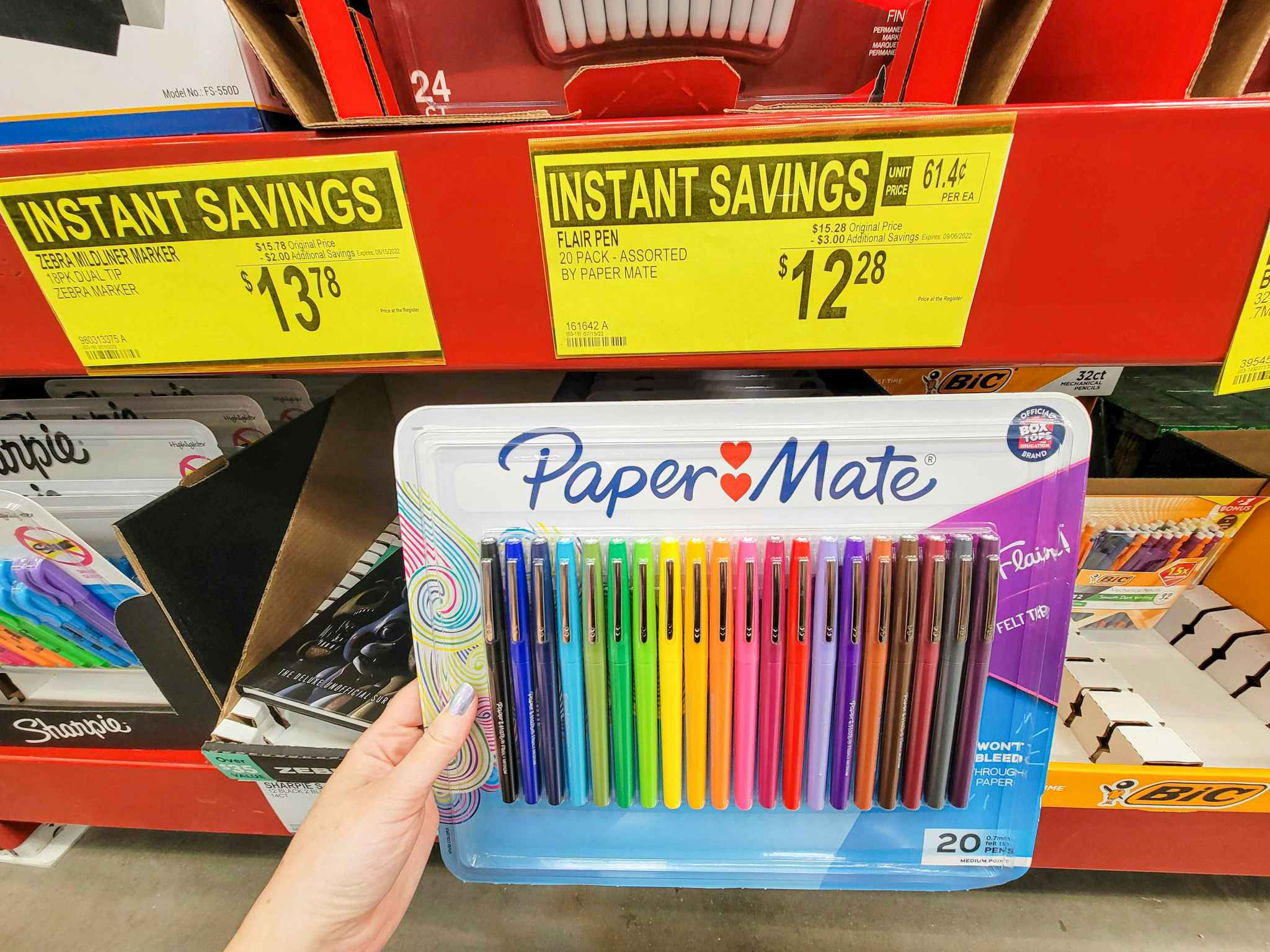hand holding a pack of 20 papermate flair pens in multiple colors