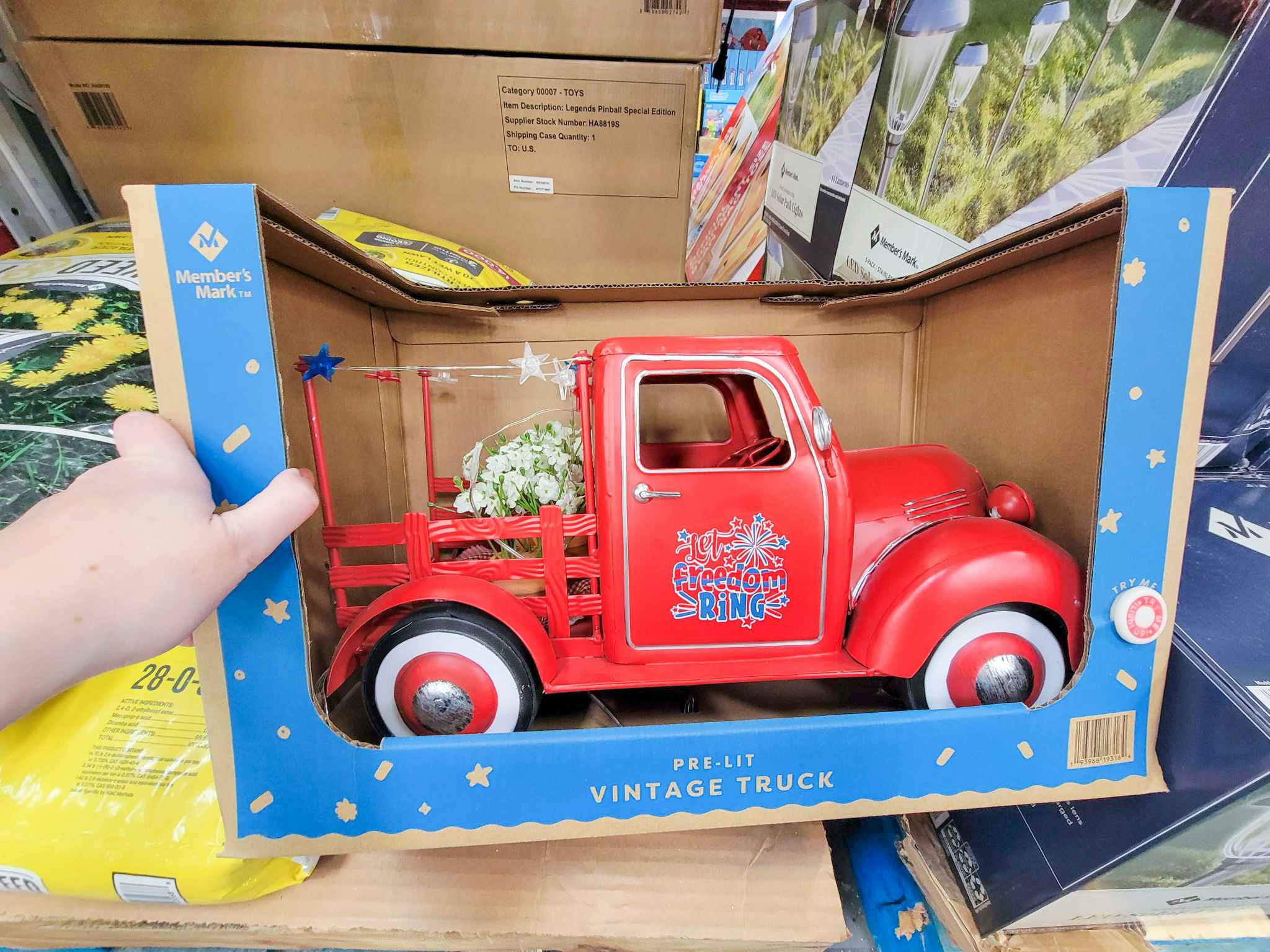 hand holding a red pre lit vintage style truck