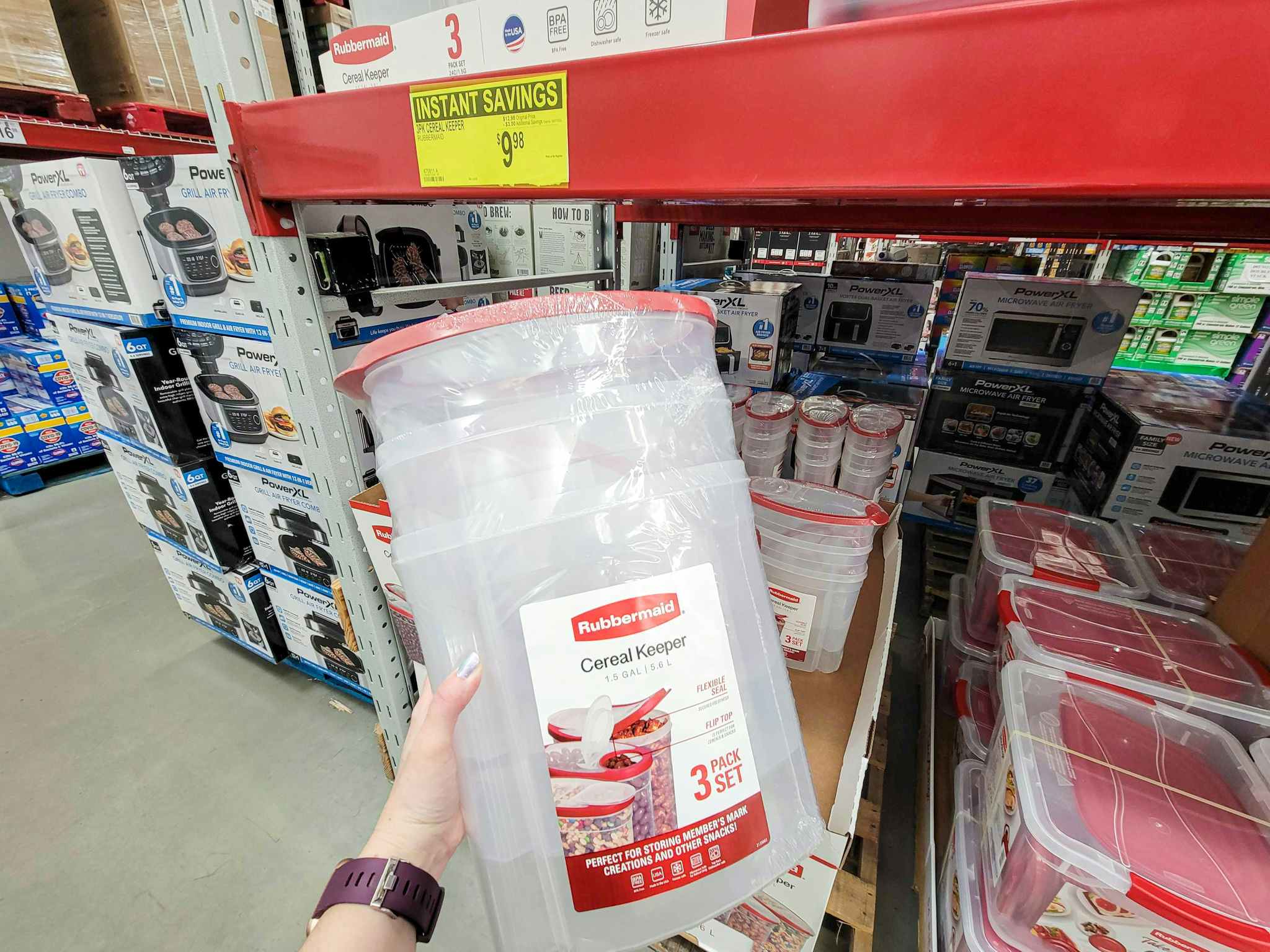 hand holding a 3-pack of rubbermaid cereal containers