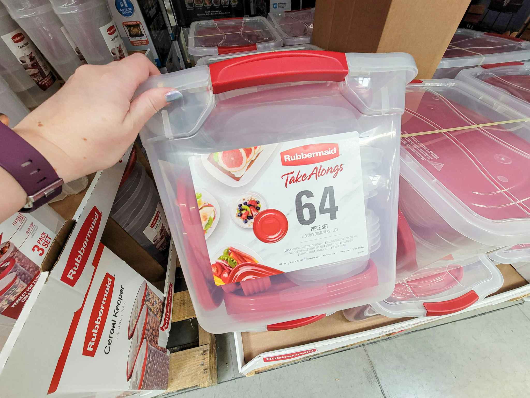 hand holding a large container of rubbermaid take alongs with 64 pieces