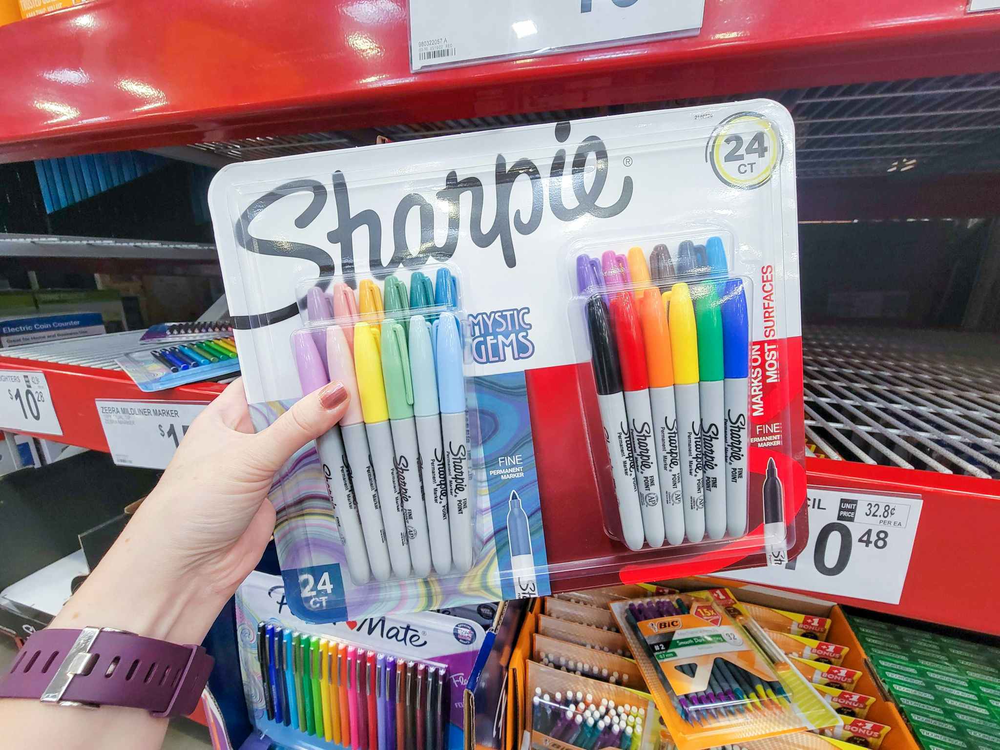hand holding a variety pack of sharpies