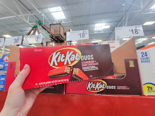 hand holding a box of strawberry chocolate kit kats