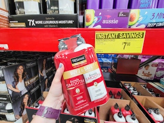 hand holding a 2 pack of tresemme plus keratin shampoo and conditioner
