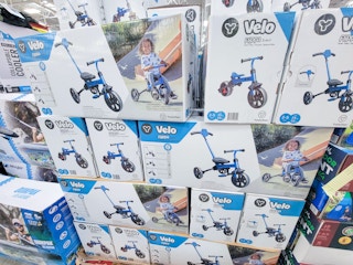 a stack of boxes with 3-in-1 trike to balance bikes