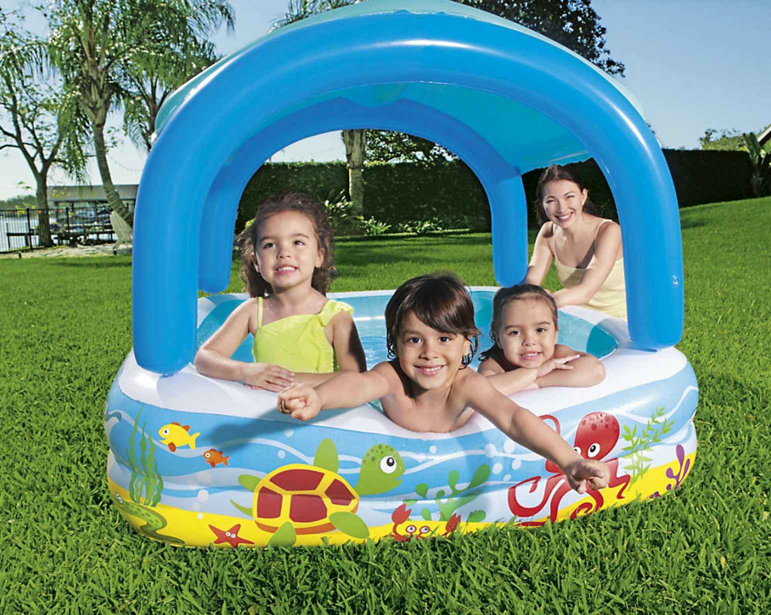 kids playing in an inflatable pool with a canopy