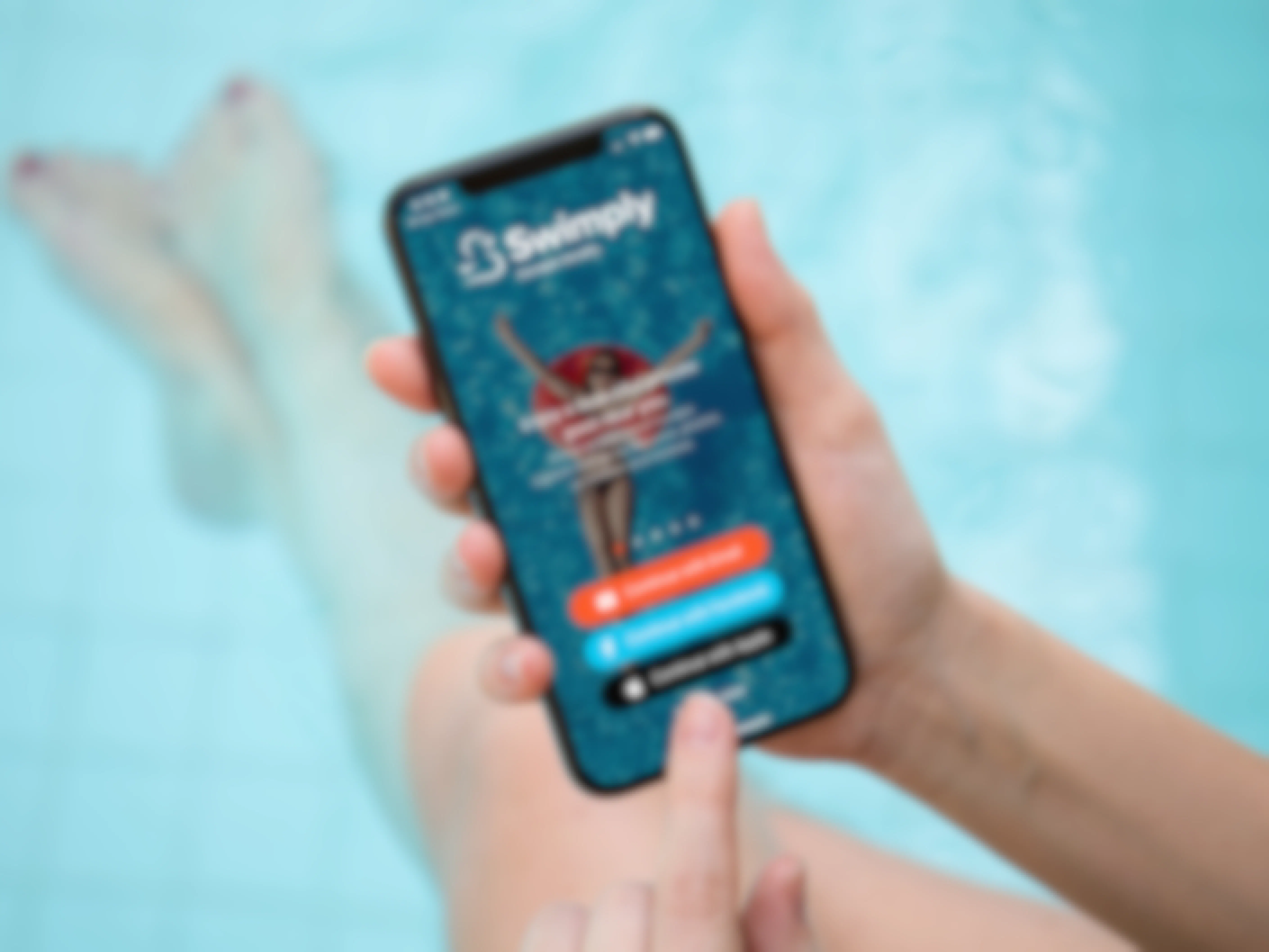 A person sitting on the edge of a pool with their feet in the water, holding a cell phone displaying the Swimply app's sign-in page.