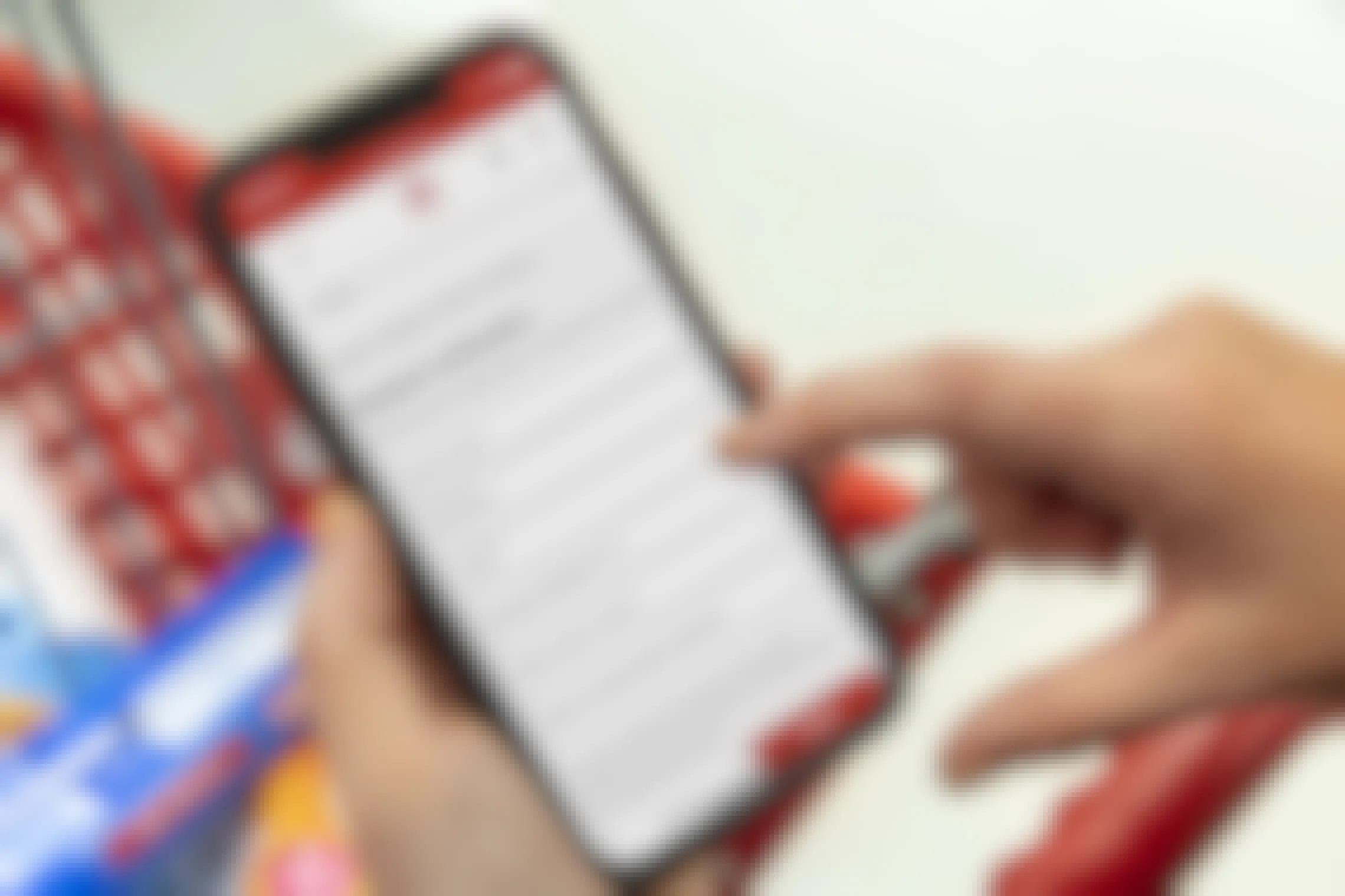 A person shopping in Target, filling out the Student Verification form on their phone in the Target Circle app.