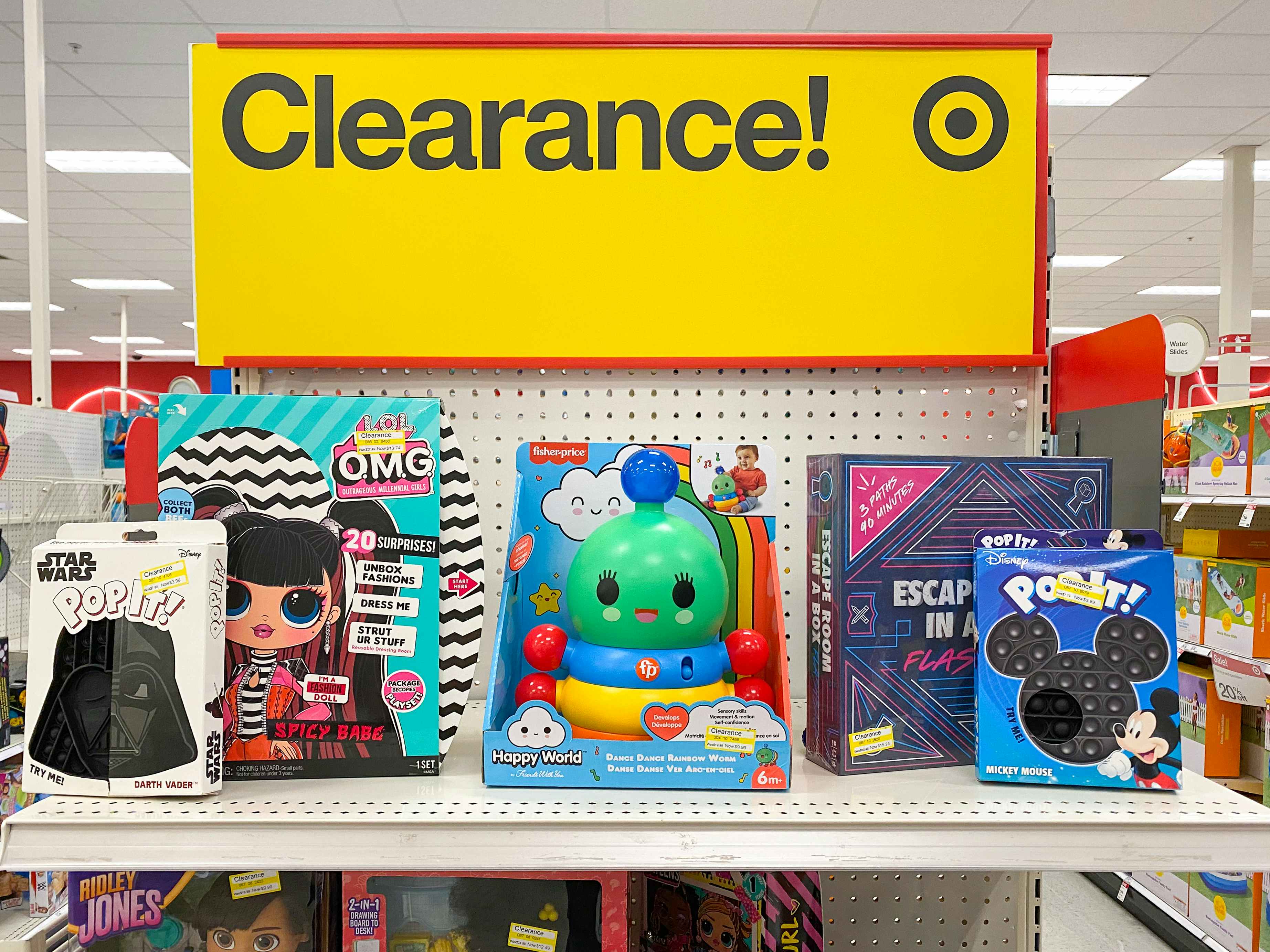 A display of clearance toys at Target with a large yellow Clearance sign.