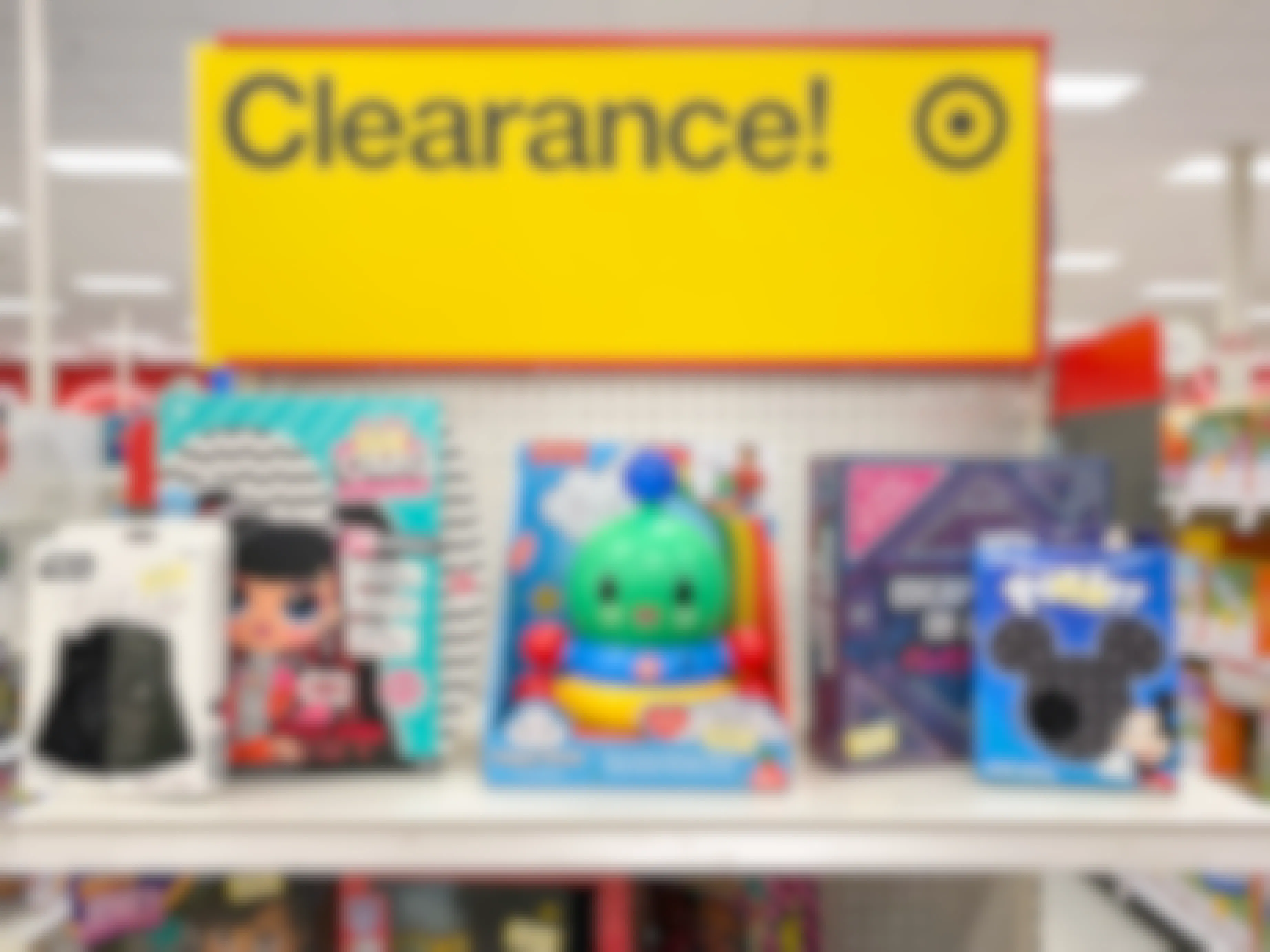 A display of clearance toys at Target with a large yellow Clearance sign.
