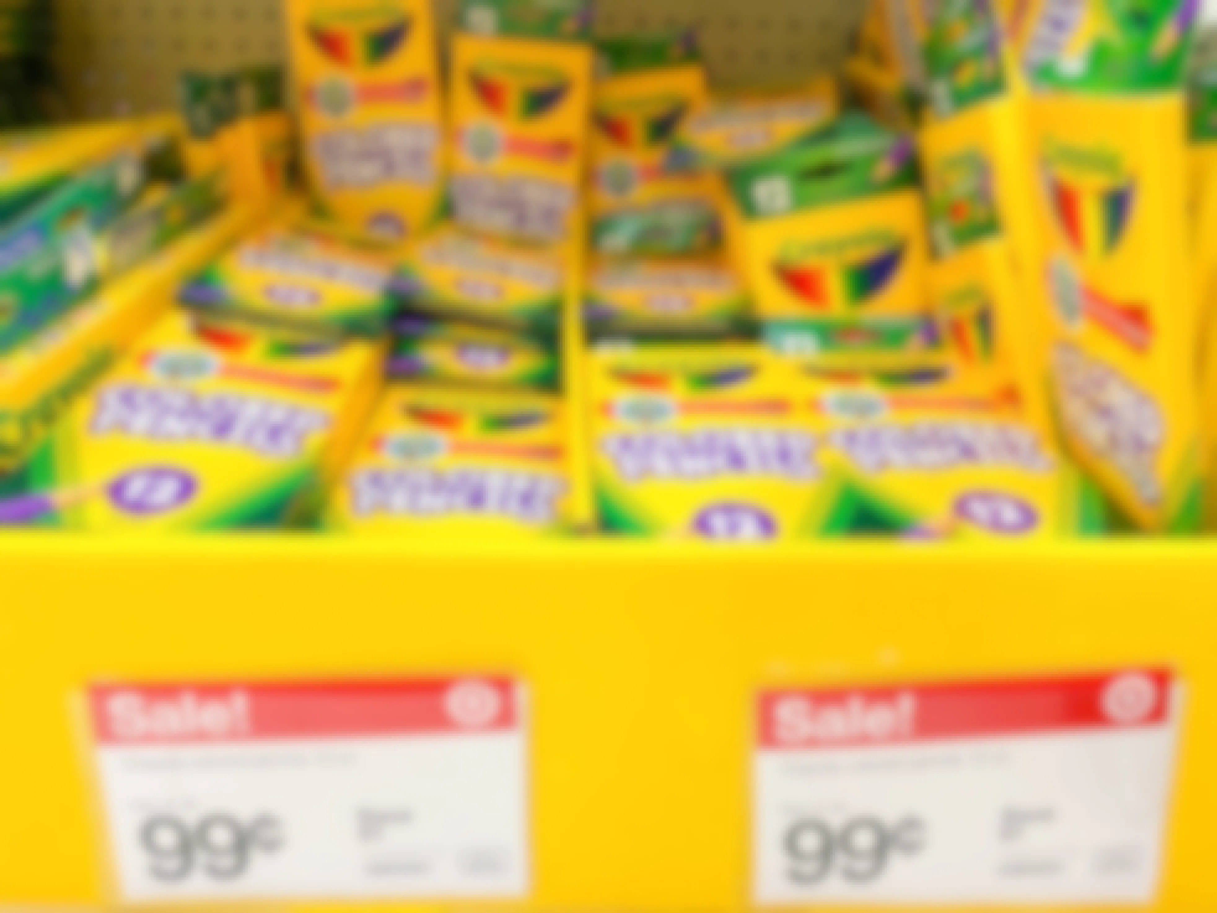 Crayola colored pencils on display at Target with sale signs pricing them at 99 cents.