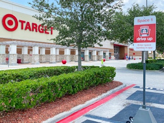 A Target drive-up parking space sign in the parking lot outside of Target.