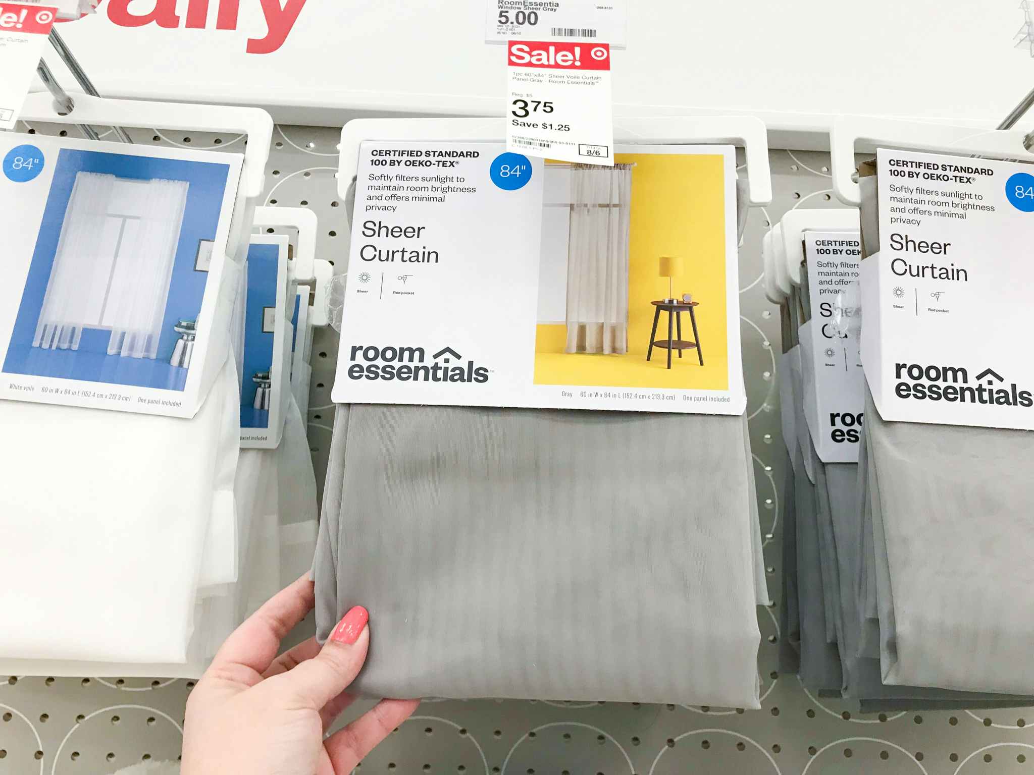 hand holding gray room essentials sheer curtain panels at target