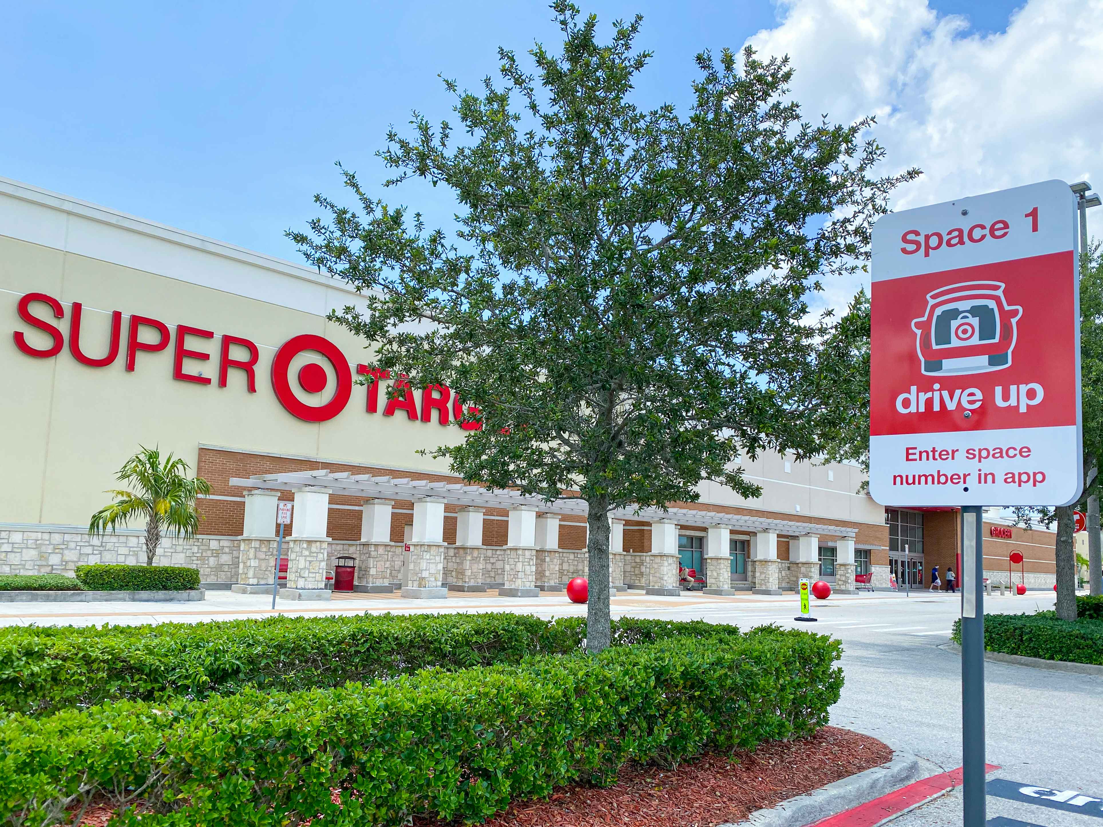 A Target drive-up parking space sign in the parking lot outside of Target.