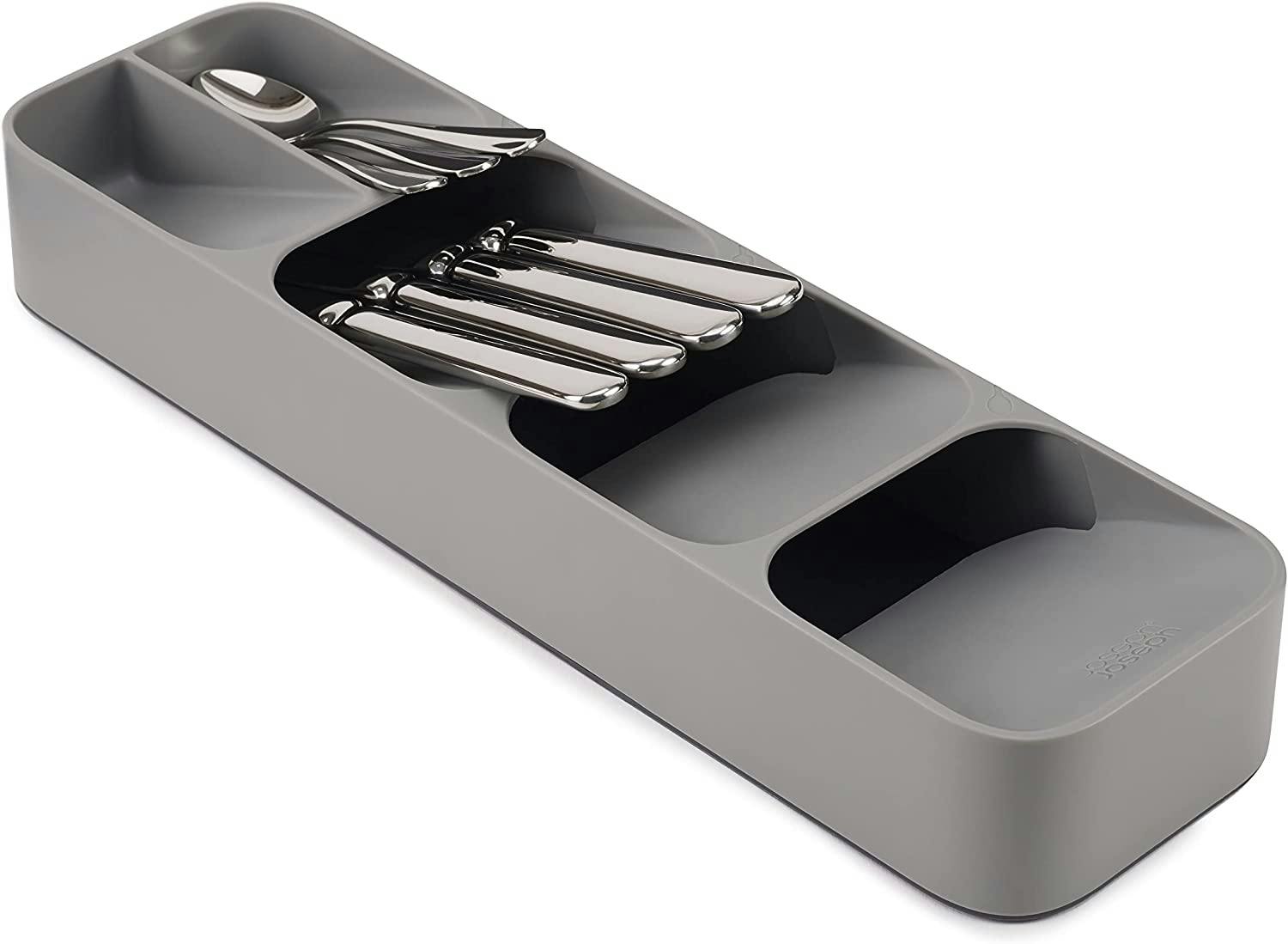 A Joseph Joseph DrawerStore Compact Cutlery Organizer with sorted silverware on a white background