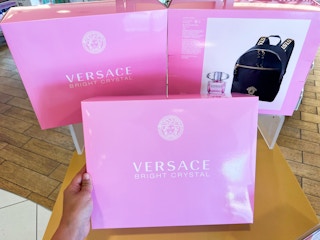 someone holding Versace Bright Crystal Summer Backpack Set