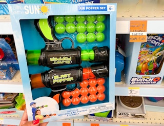 hand holding box of a set of air poppers next to clearance tag