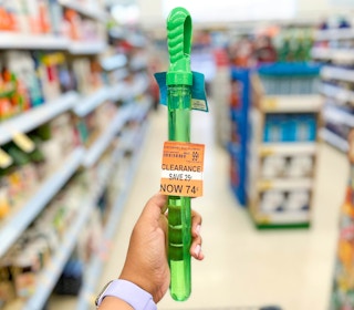 hand holding bubble wand in center of aisle with clearance tag on item