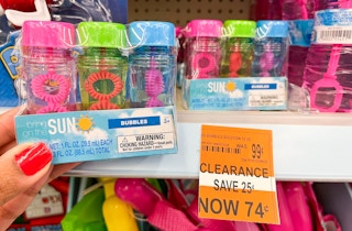 hand holding a box of mini bubble bottles next to clearance tag