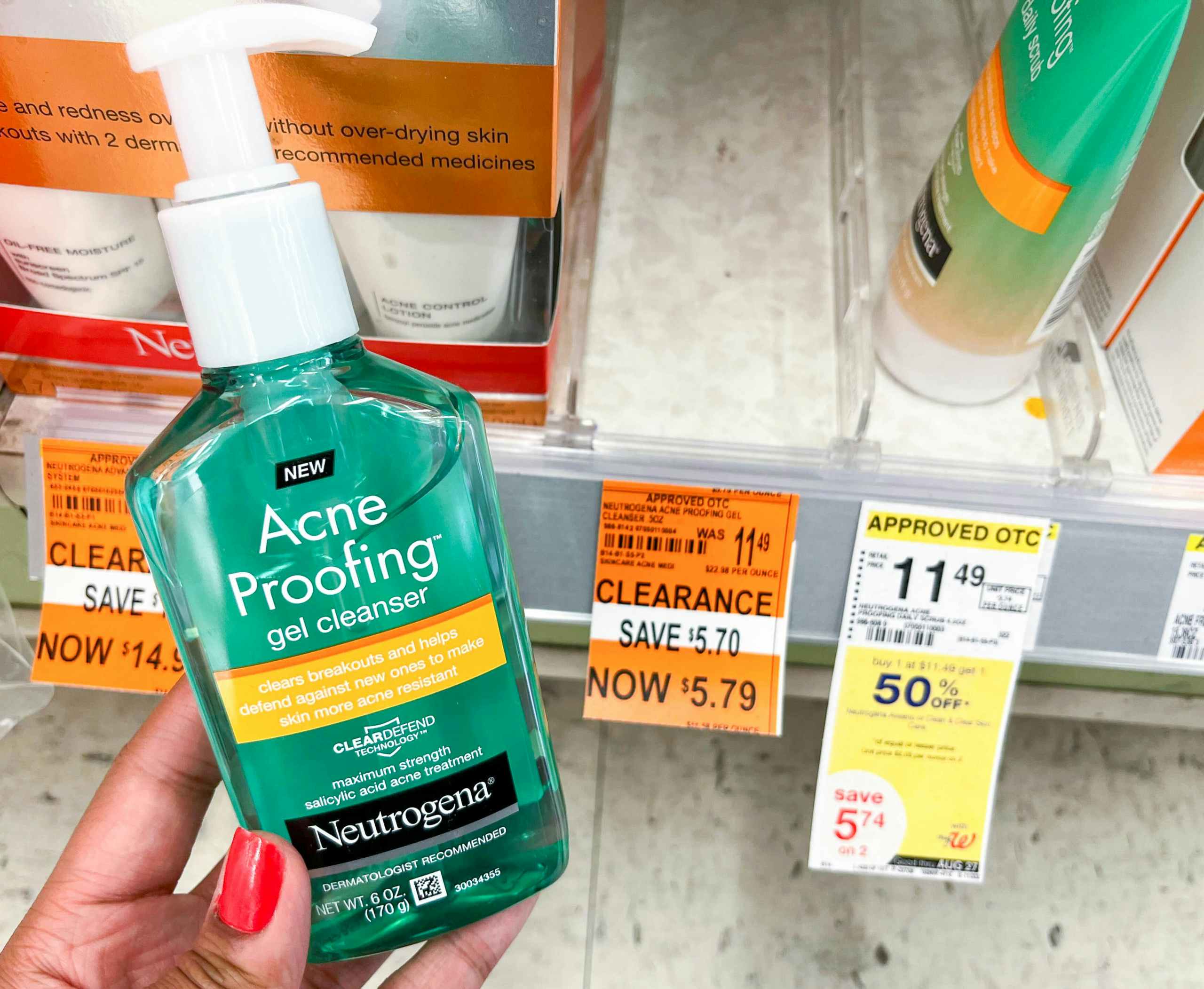 hand holding bottle of Neutrogena acne proofing gel cleanser next to clearance tag