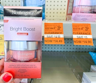 hand holding Neutrogena Bright Boost cream with clearance tag next to it