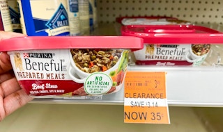 hand holding a container of Purina Beneful Prepared Meals next to clearance tag