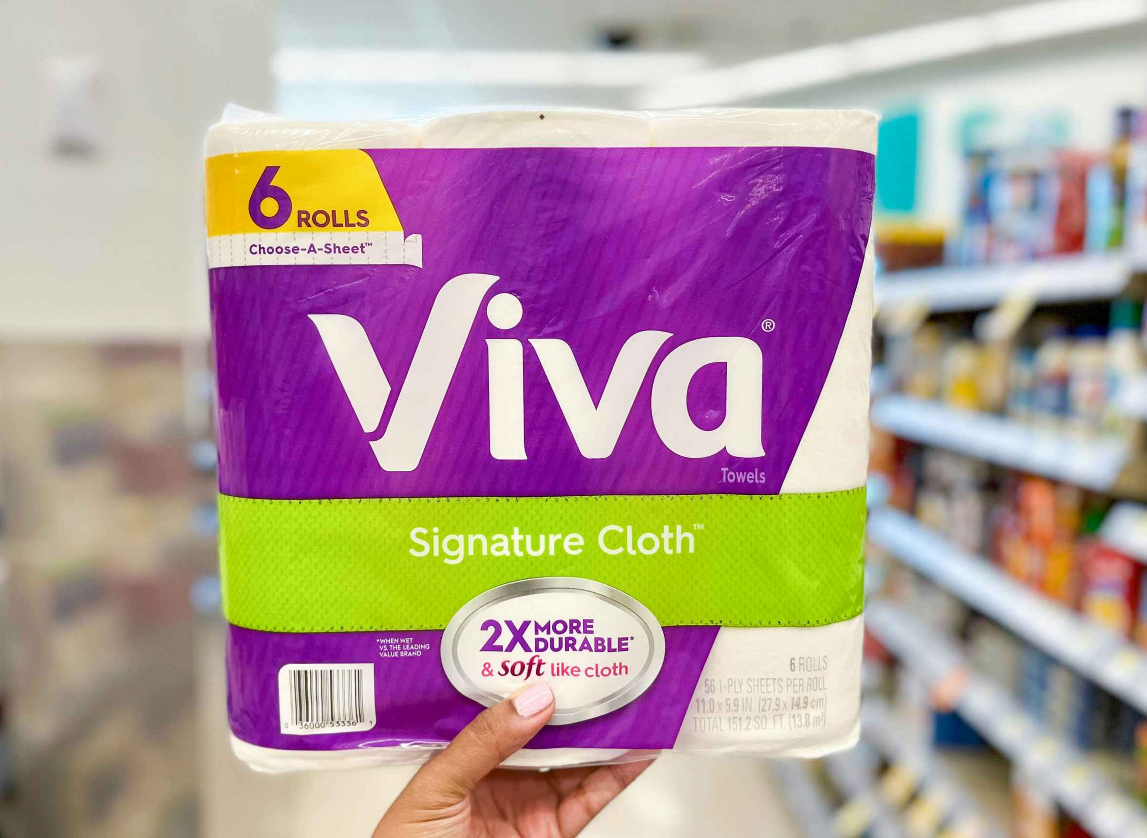 hand holding a pack of Viva Signature Paper Towels in aisle