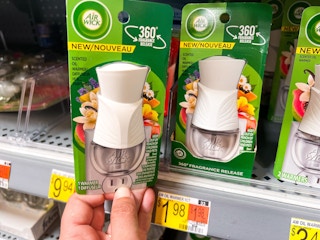 Air Wick Plug In Scented Oil Warmer held in front of shelf at Walmart. Price tag states that the price is $1.98.