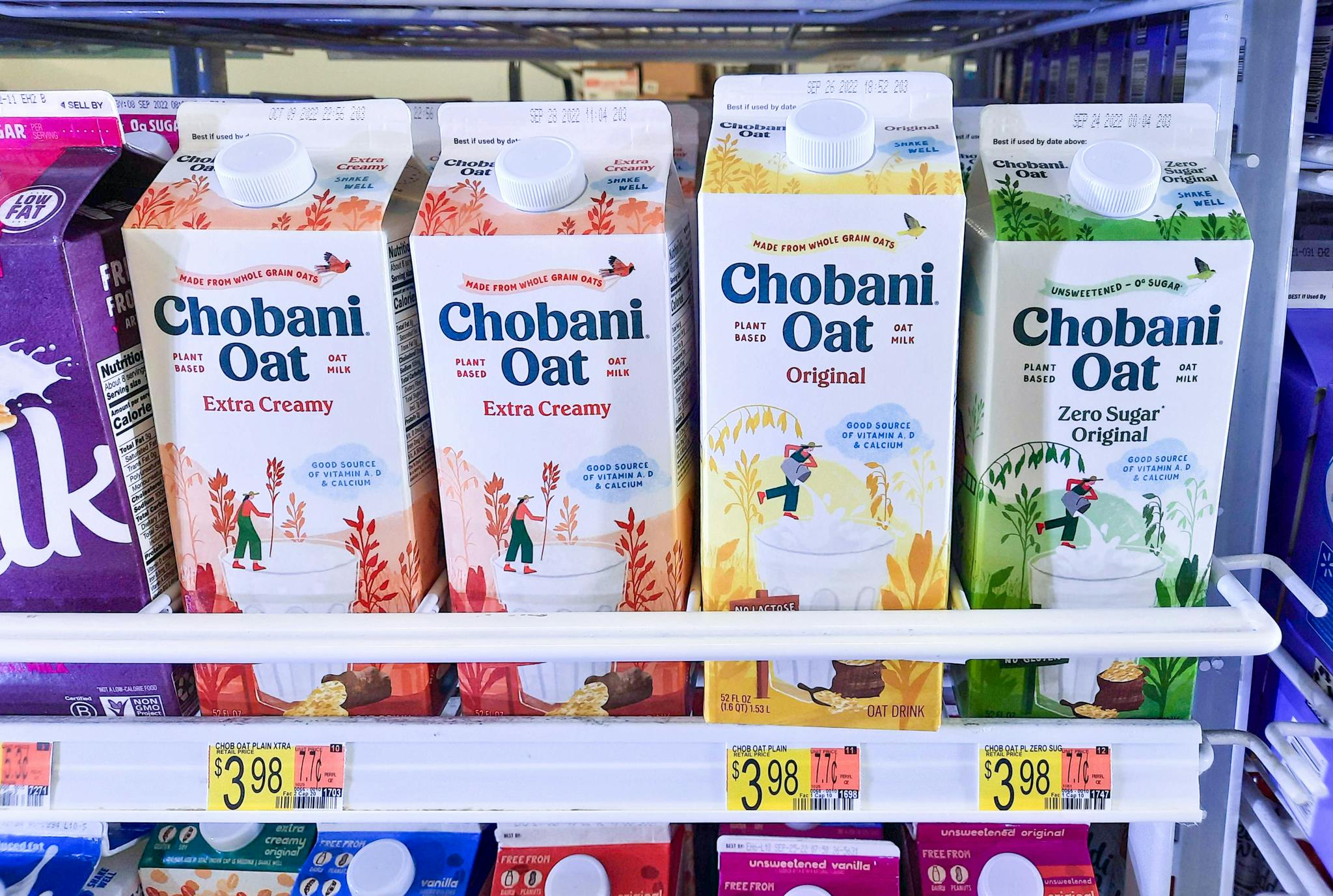 Chobani Original, Extra Creamy, and Zero Sugar Original Oat Milk on dislay at Walmart. Price tags in front of all three products read $3.98.