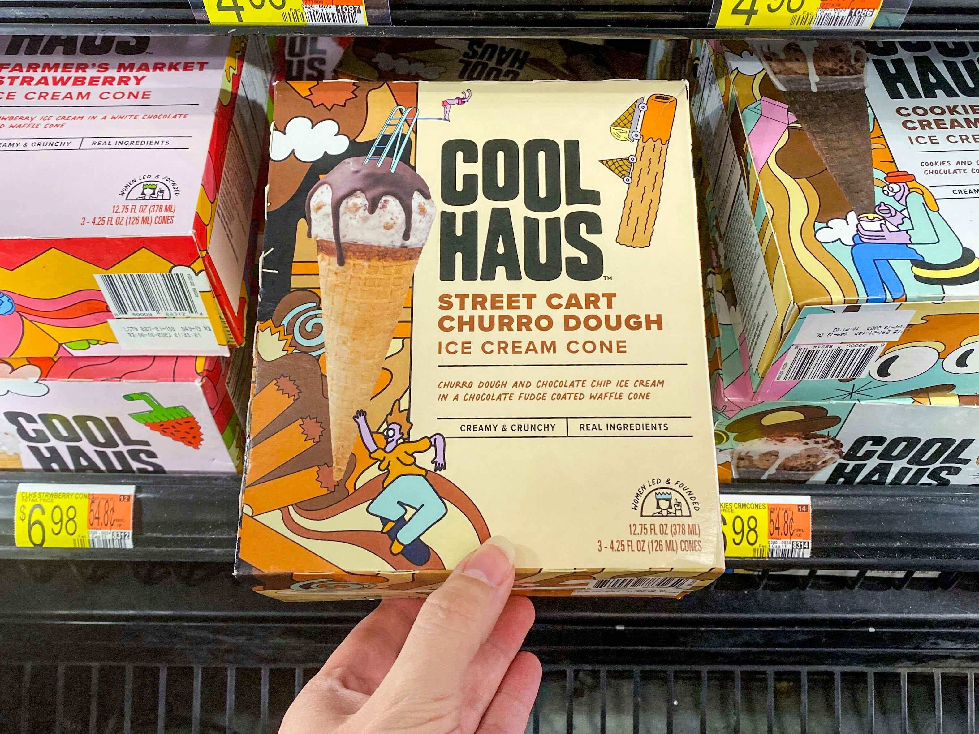 Hand grabbing a box of Coolhaus Ice Cream Cones off the shelf at Walmart