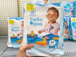 hand holding hello bello swim dipes at walmart