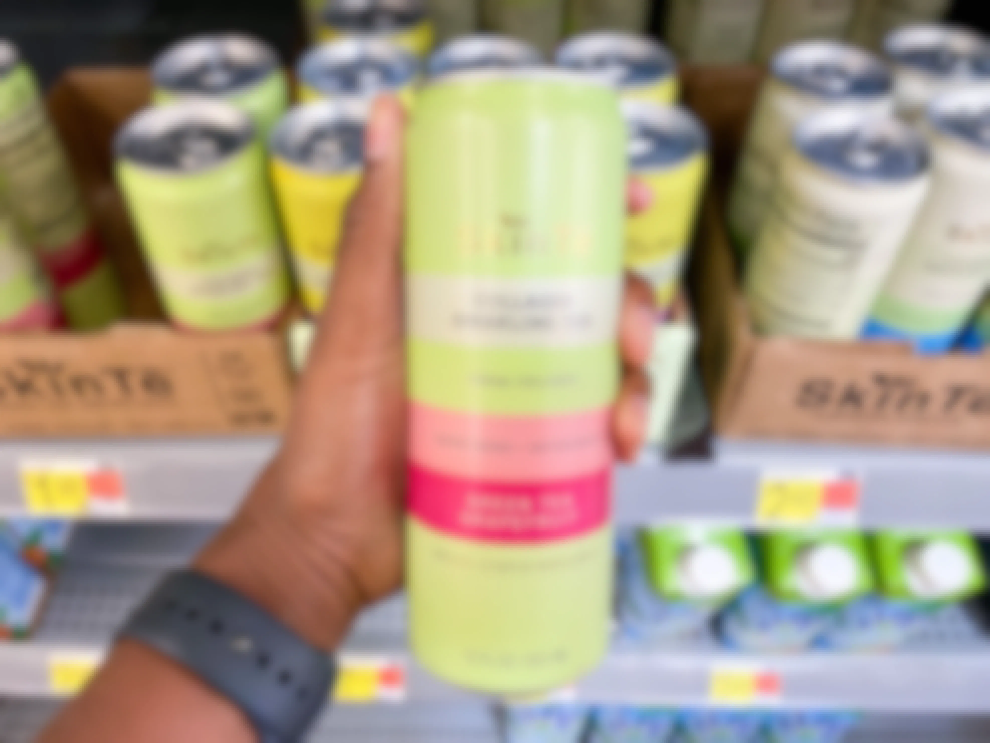 Skinte Collagen Sparkling Tea held in front of shelf at Walmart