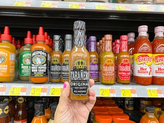 hand holding tabanero hot sauce at walmart