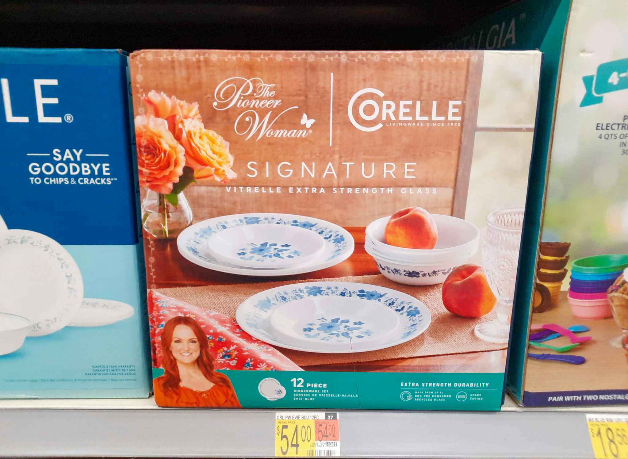 The Pioneer Woman by Corelle 12-Piece Dinnerware set on shelf at Walmart. Price tag indicates that the price is $54.