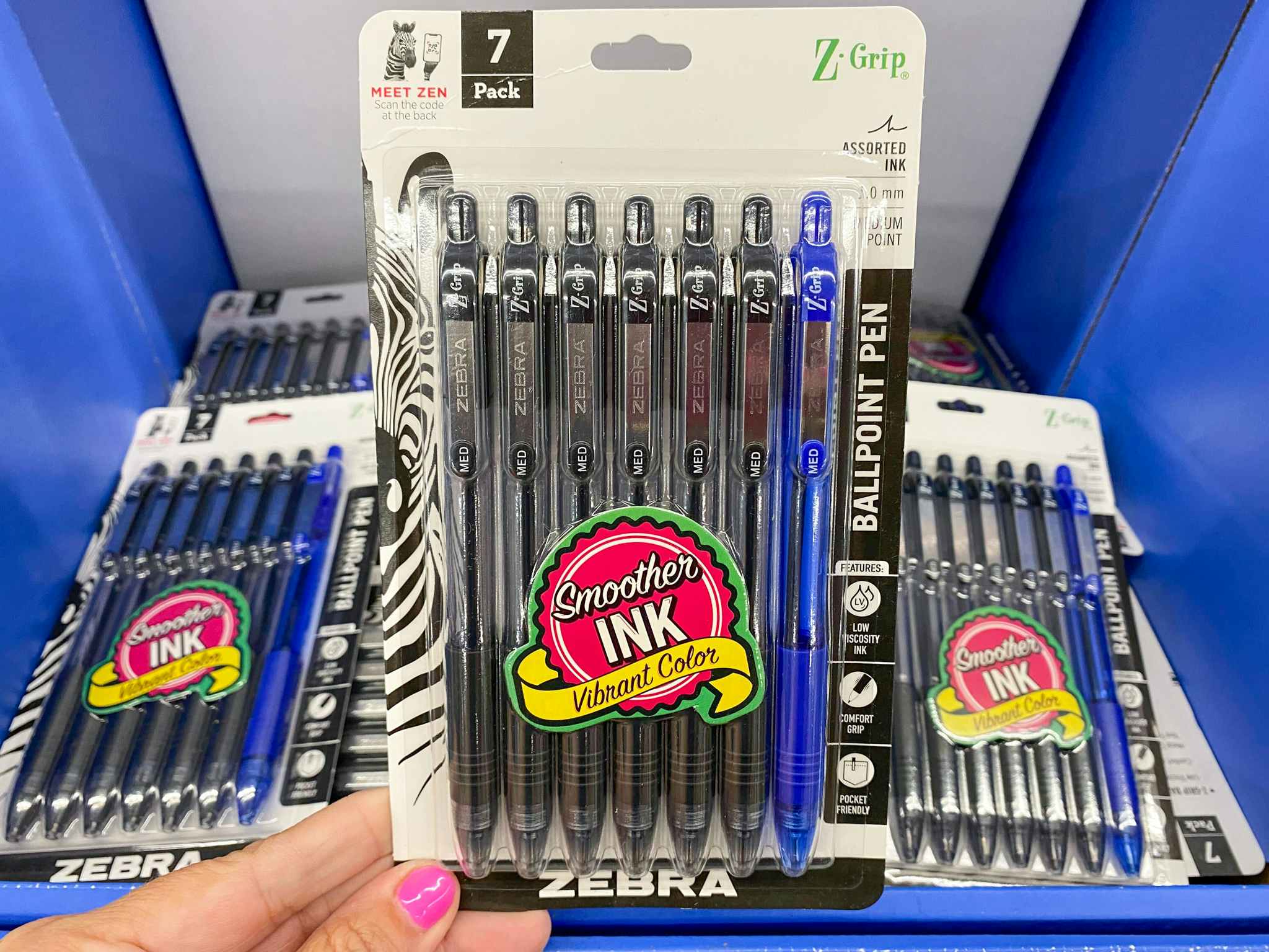 Hand holding 7-count package of Zebra Ballpoint Pens at Walmart